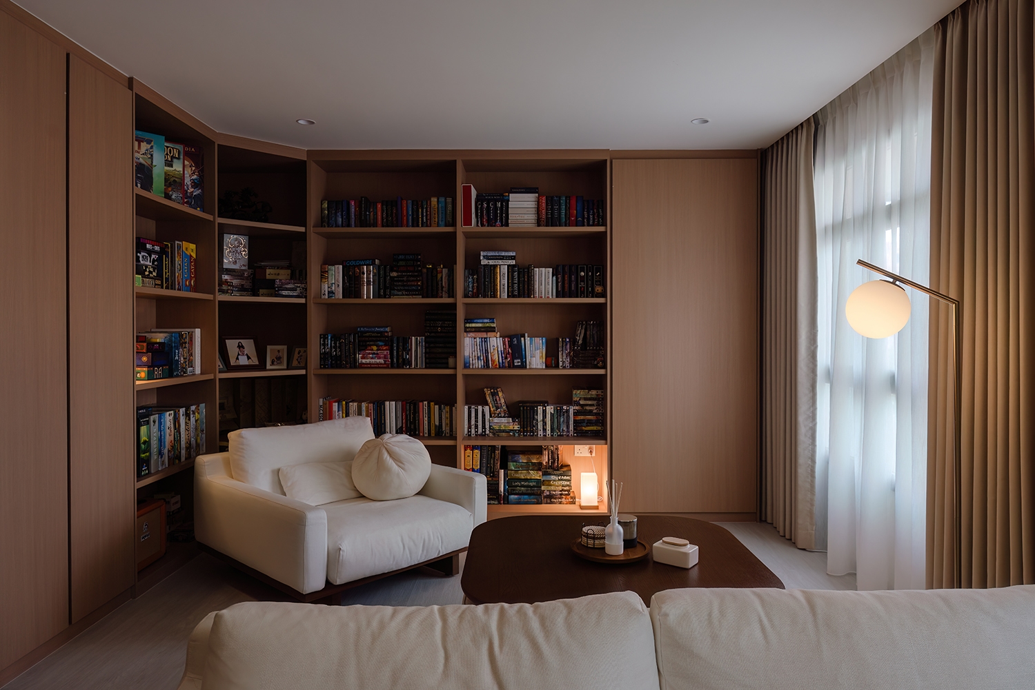 Japandi living room with warm-wood built-in shelving
