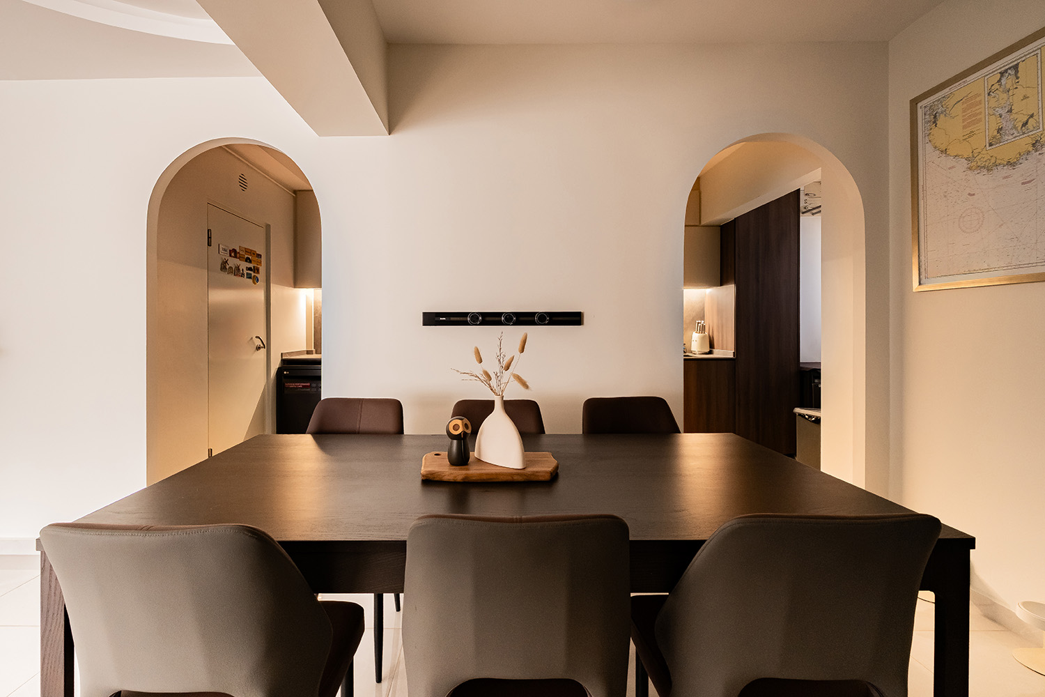 Wabi-sabi HDB dining area framed by arched openings